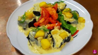 Tortelloni neri mit Mango-Fenchel-Gemüse und Safranschaum